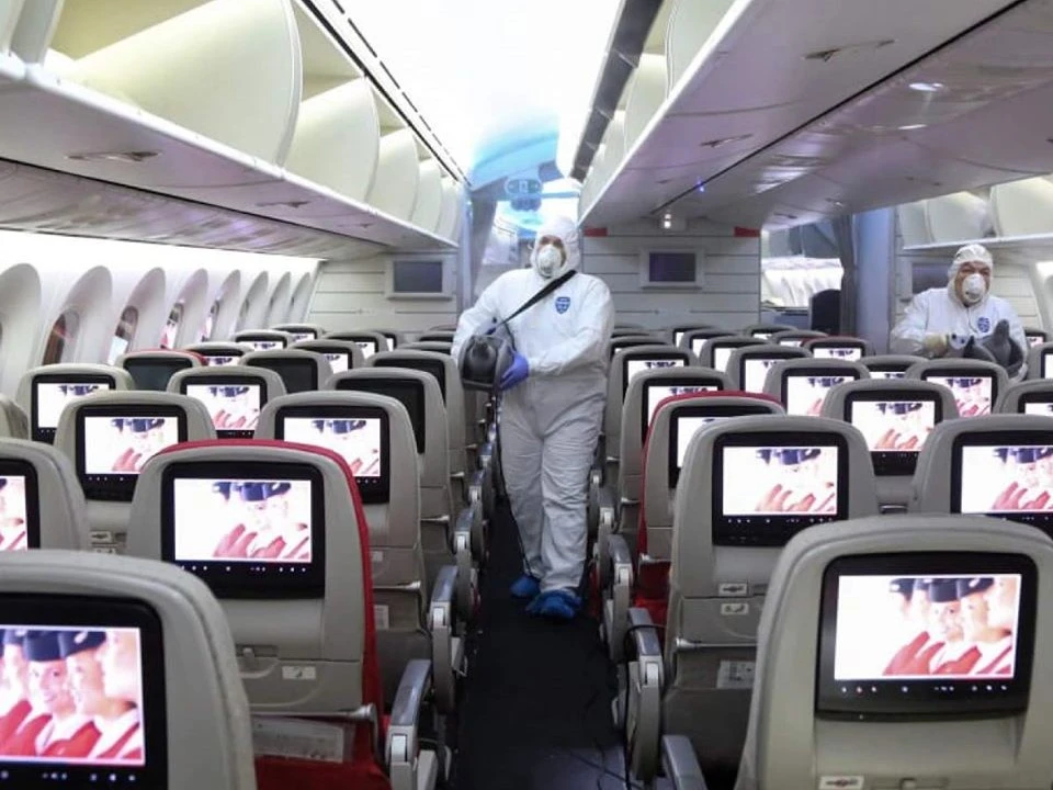 Above, sanitation crews sterilize the cabin of a Jordanian Airlines aircraft to guard against coronavirus. (Jordanian Airlines)