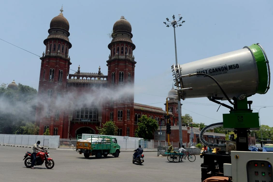 Municipal workers spray disinfectant on a street during a government-imposed nationwide lockdown as a preventive measure against the COVID-19 coronavirus, in Chennai on May 01, 2020. (AFP)