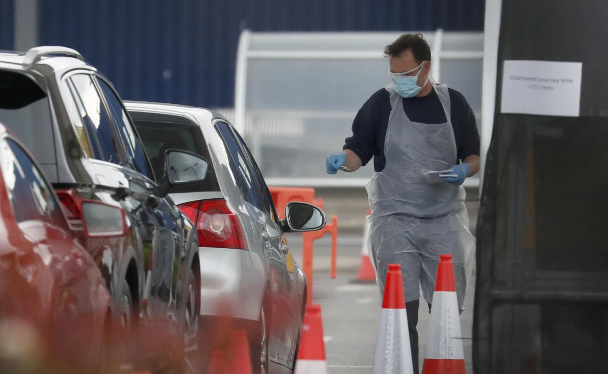 Staff work at a the COVID-19 testing facility at Ikea near the Wembley stadium in London, Wednesday, April 29, 2020. (AP)