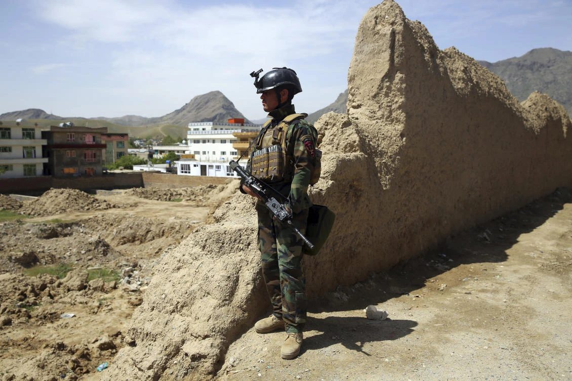 An Afghan special force member stands guard at the site of a suicide bomber attack on the outskirts of Kabul, Afghanistan, Wednesday, April 29, 2020. (AP/Rahmat Gul)
