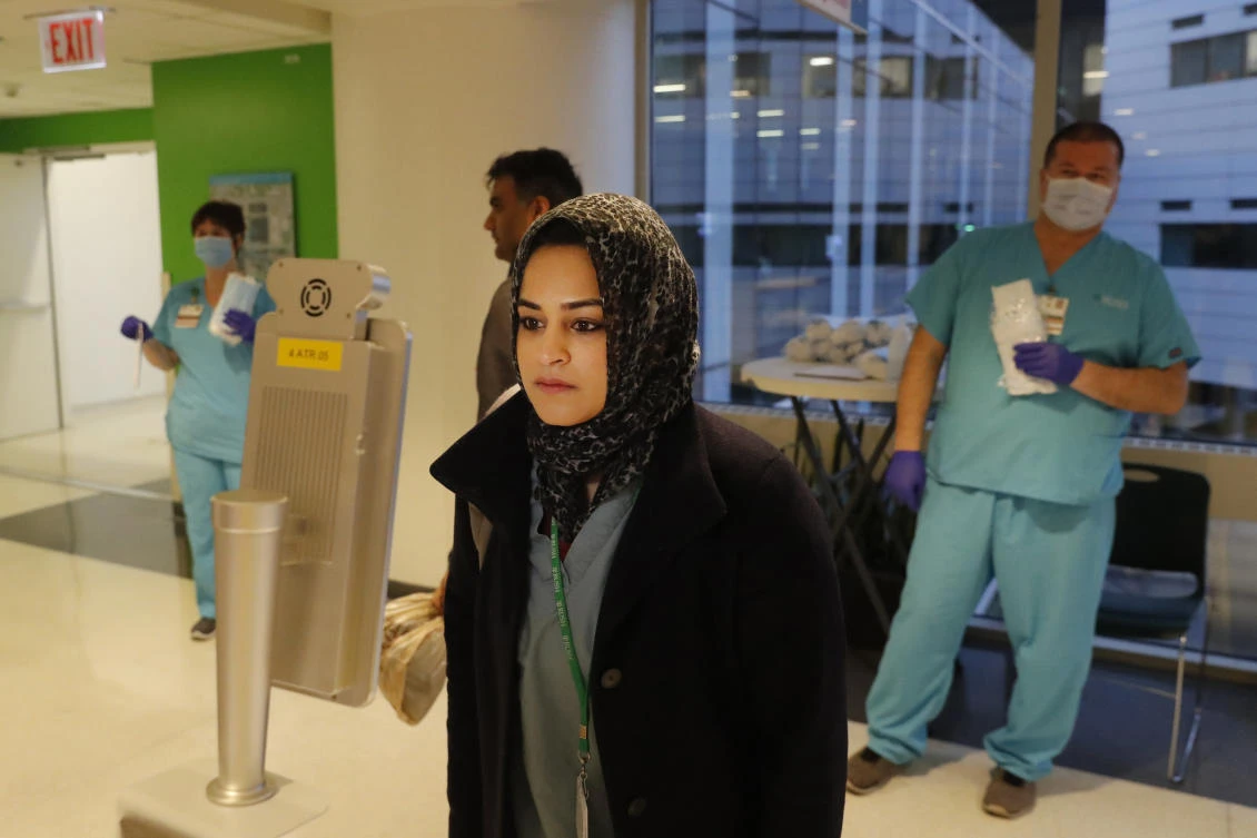 RUSH Hospital respiratory therapist Jumana Azam pauses before a face temperature scanner as she reports for her early morning shift at the hospital in Chicago on Wednesday, April 22, 2020. (AP)
