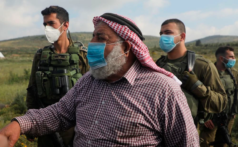 A Palestinian protester from al-Sawiyah village south of Nablus city in the occupied West Bank reacts as he is prevented by Israeli soldiers from accessing his lands on May 2, 2020. (AFP)