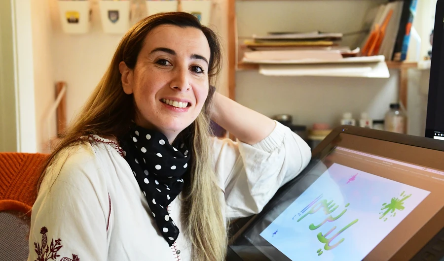 Artist Reem Ali Adeeb poses in her studio apartment in Los Angeles, California on April 29, 2020, where she is developing online tutorials in Arabic for children about art, including drawing and reading. (AFP)