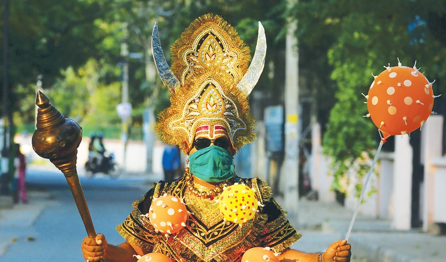 A man dressed as ‘Yamraj’, the Hindu mythical angel of death, campaigns to raise awareness on the importance to stay home and maintain social distancing during an event organised by Delhi police as India continues to remain under a nationwide lockdown as a preventive measure against the spread of the COVID-19 coronavirus, in New Delhi on April 28, 2020. (AFP)