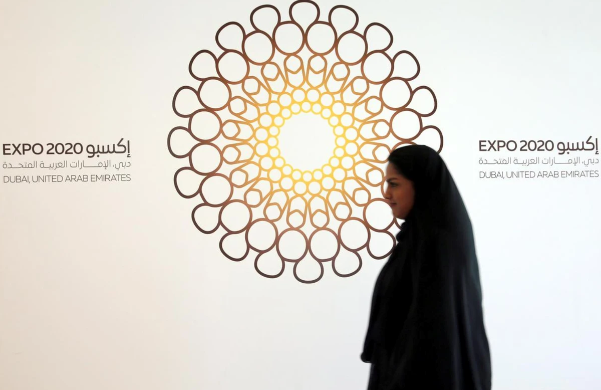 A woman walks past the logo of Expo 2020 in Dubai, United Arab Emirates, April 3, 2017. (REUTERS/File Photo)