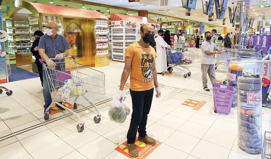 People follow social distancing markings as they line up at a shopping mall after the Saudi government eased a curfew and allowed stores to open, following the outbreak of the coronavirus disease (COVID-19), in Riyadh. (Reuters)