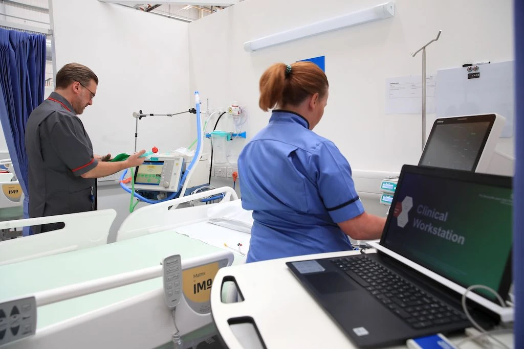 Staff prepare bays at the NHS Nightingale Hospital North East in Sunderland, northeast England on May 5, 2020 providing 460 beds for patients with coronavirus. (AFP)