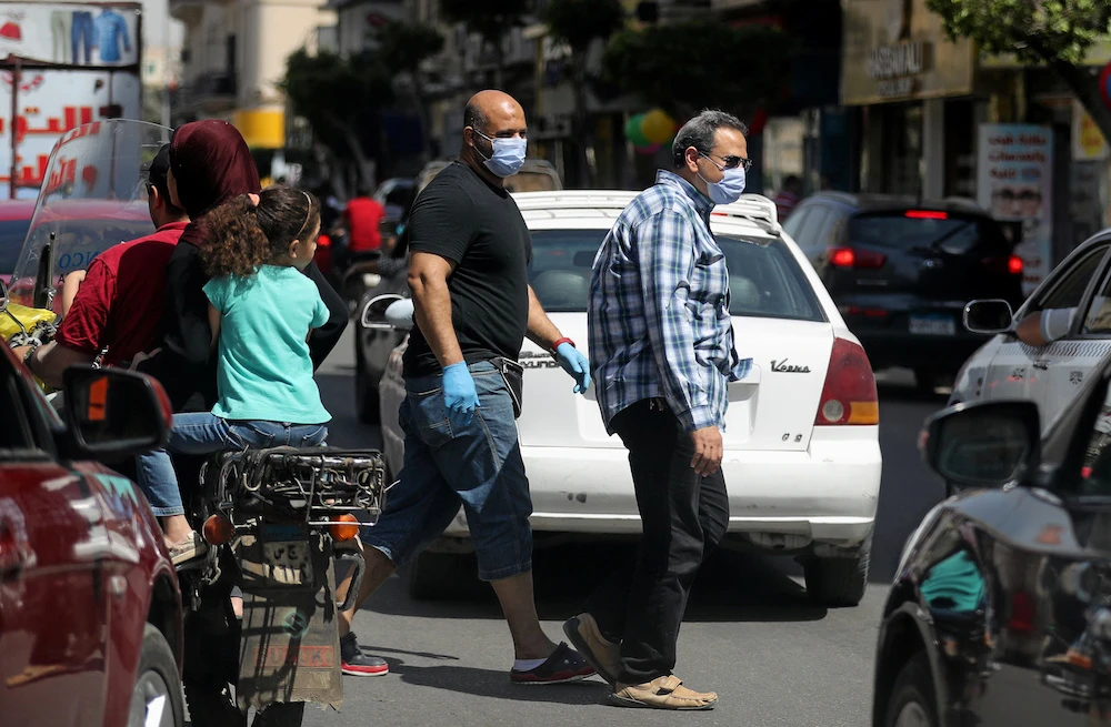 Men wearing protective face masks walk in downtown Cairo, amidst concerns about the spread of coronavirus (COVID-19), Egypt, May 2, 2020. (Reuters)