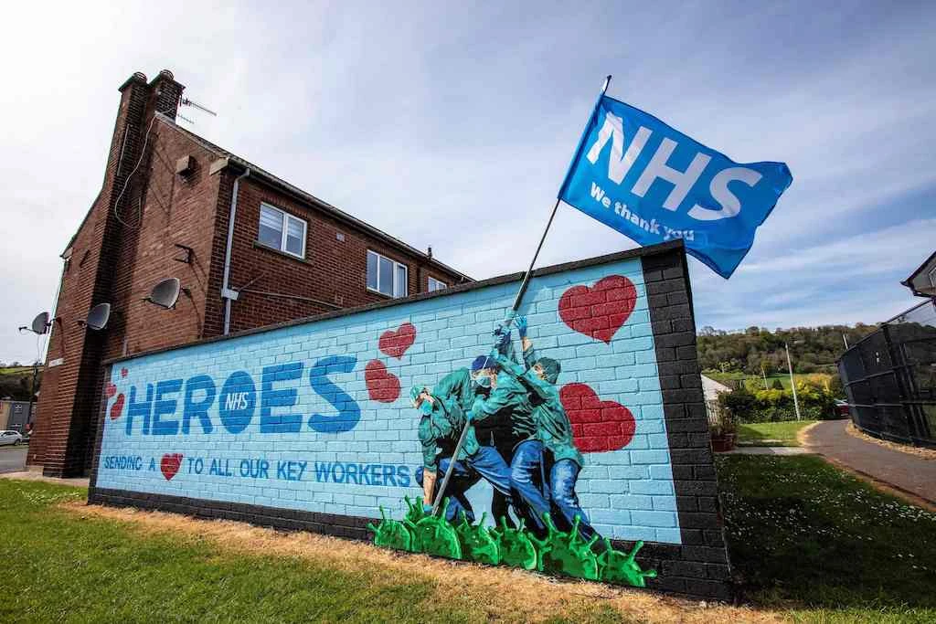 Street art graffiti paying tribute to the NHS, (National Health Service), is pictured on a wall in Glynn, north of Belfast on May 5, 2020. (AFP)