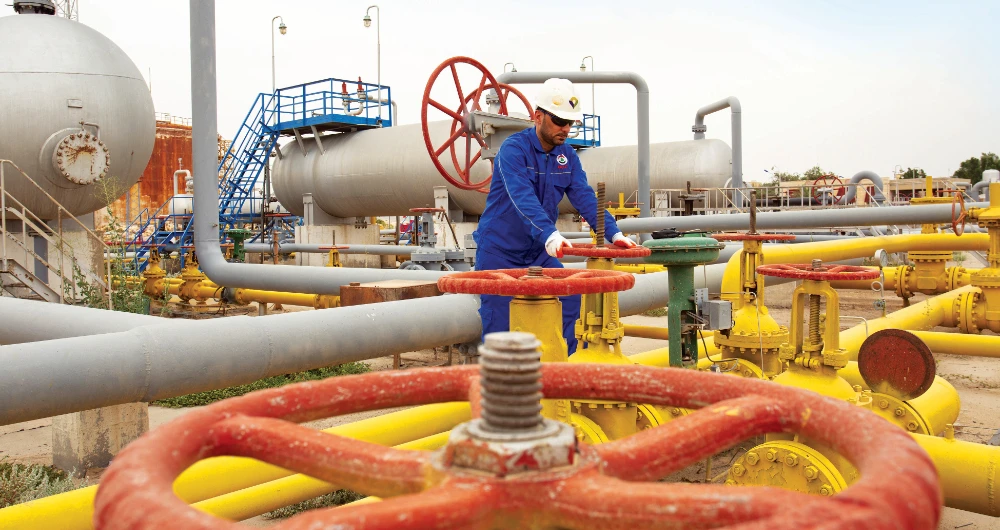 Work at the Nahr Bin Omar natural gas field in Iraq, where major oil production cutbacks are expected. (AFP)