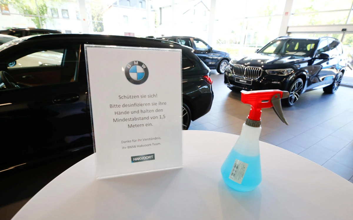 Above, disinfectant and distancing rules in the sales room of the BMW dealer Hakvoort in Koenigswinter, Germany on April 20, 2020. (Reuters)