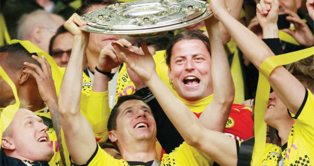In this May 5, 2012 file photo, striker Robert Lewandowski of Borussia Dortmund celebrates with the German Bundesliga title. (Files/Reuters)