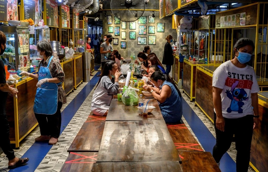 Residents eat at a food hall as the Thai government relaxed measures to combat the spread of coronavirus, in Bangkok on May 5, 2020. (AFP)