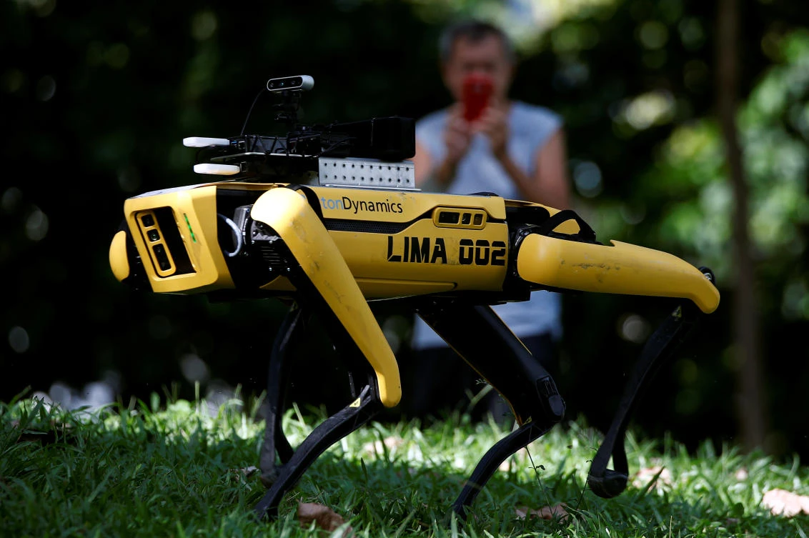 A four-legged robot dog called SPOT patrols a park as it undergoes testing to be deployed as a safe distancing ambassador, following the coronavirus disease (COVID-19) outbreak, in Singapore May 8, 2020. (Reuters/Edgar Su)