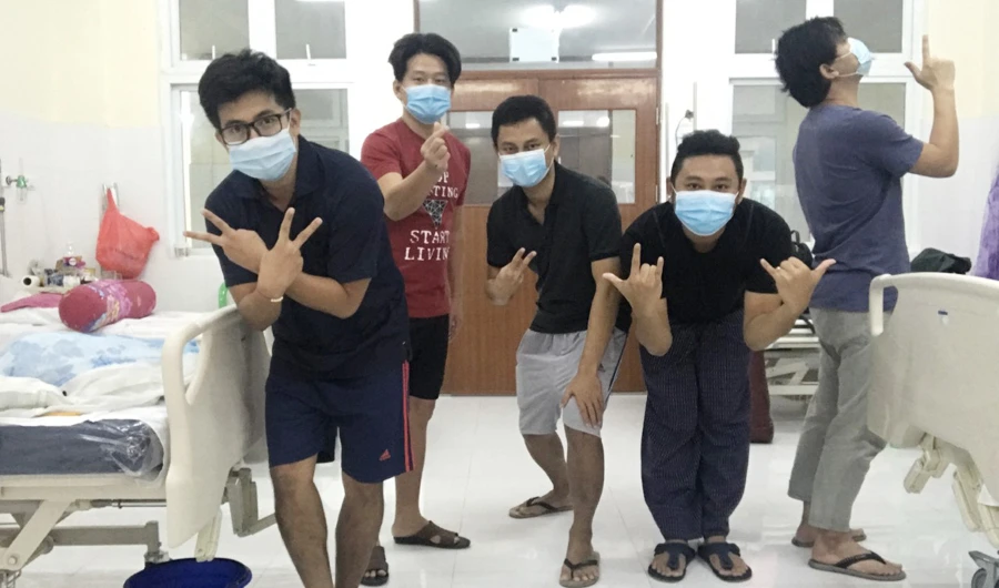 Five COVID-19 patients who launched an awareness campaign to help address the stigmatization of people affected by the virus are seen at their isolation room at a hospital in Yangon, Myanmar. (Photo courtesy: Sithu Wu)