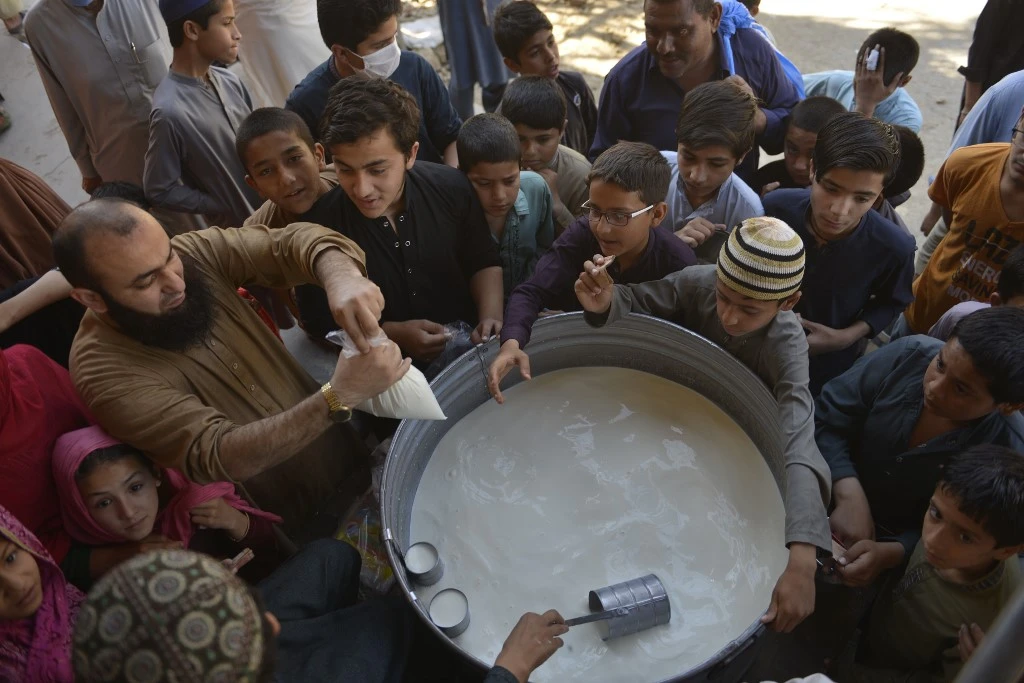 Above, customers flock to a milk shop in Rawalpindi on May 5, 2020. Pakistan has began easing its nationwide lockdown as a preventive measure against coronavirus. (AFP)