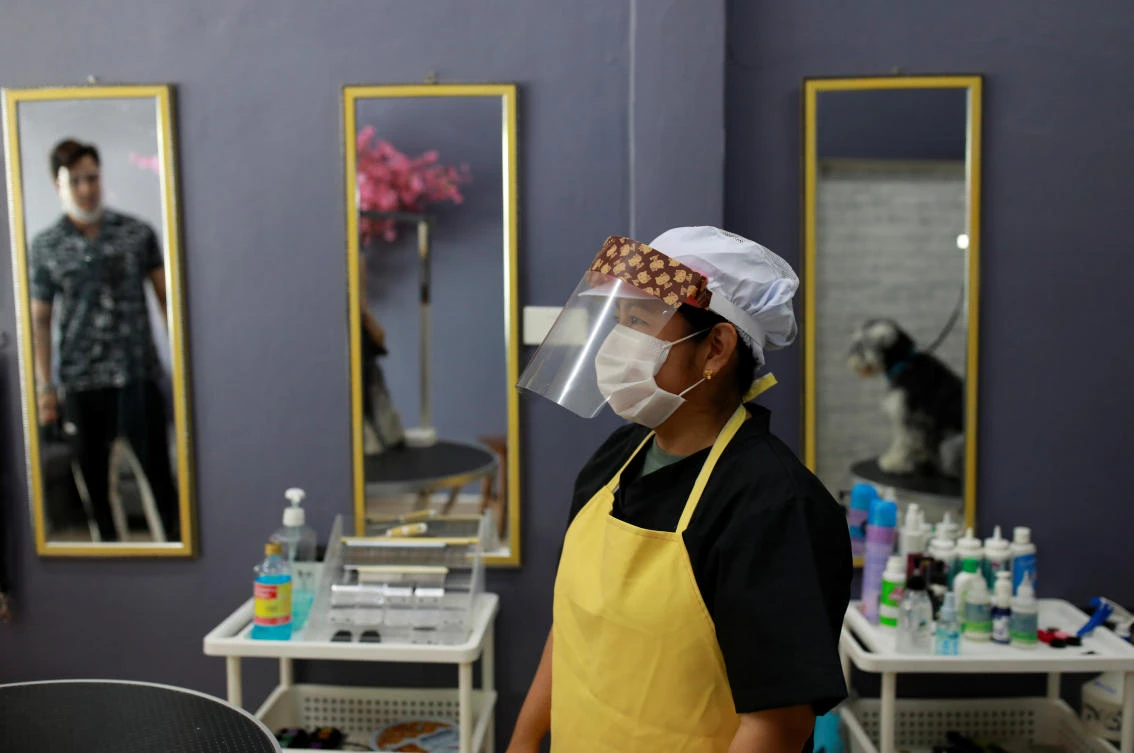 Slowing numbers of new cases have prompted Thailand to cautiously allow some businesses to reopen after weeks of semi-lockdown. Above, a at a dog hair saloon in Bangkok on May 4, 2020. (Reuters)
