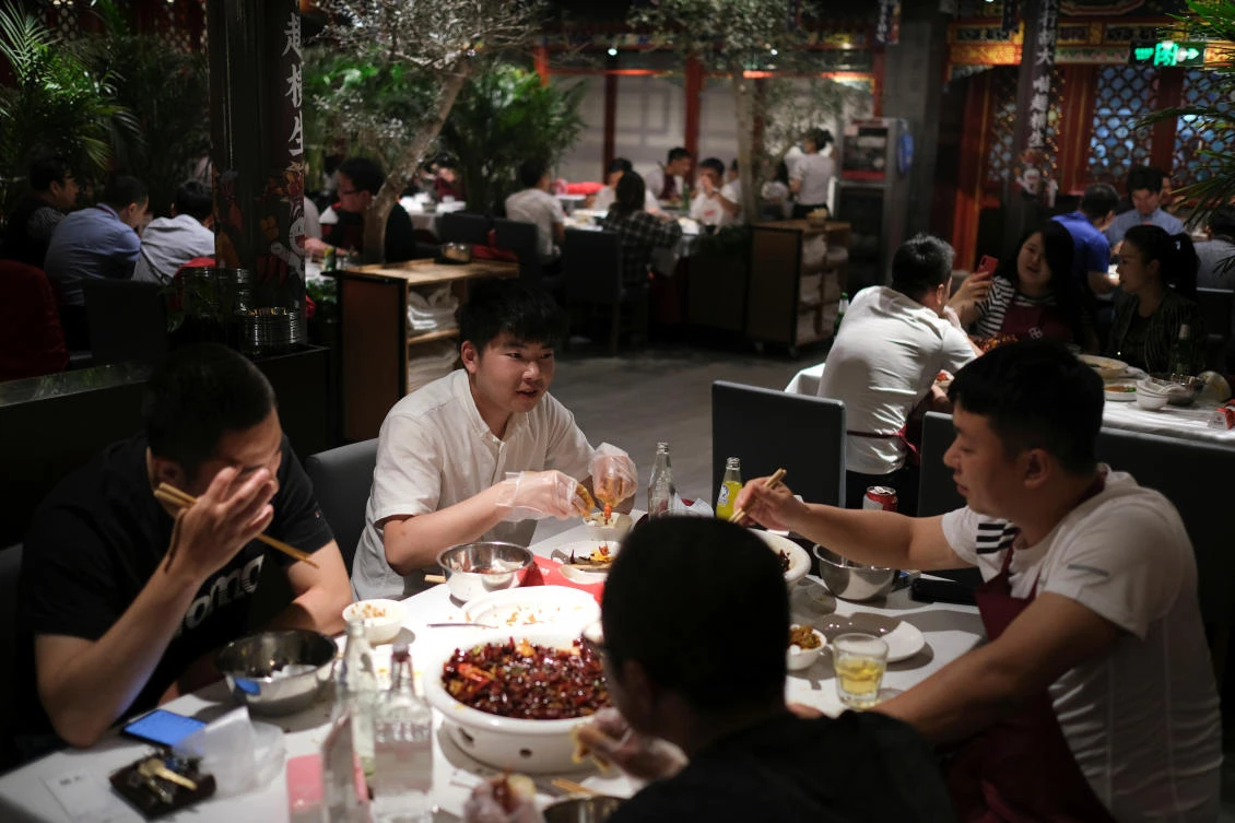 Above, people enjoy their meal at a restaurant in Beijing. China was once the hot spot of coronavirus infections. (Reuters)
