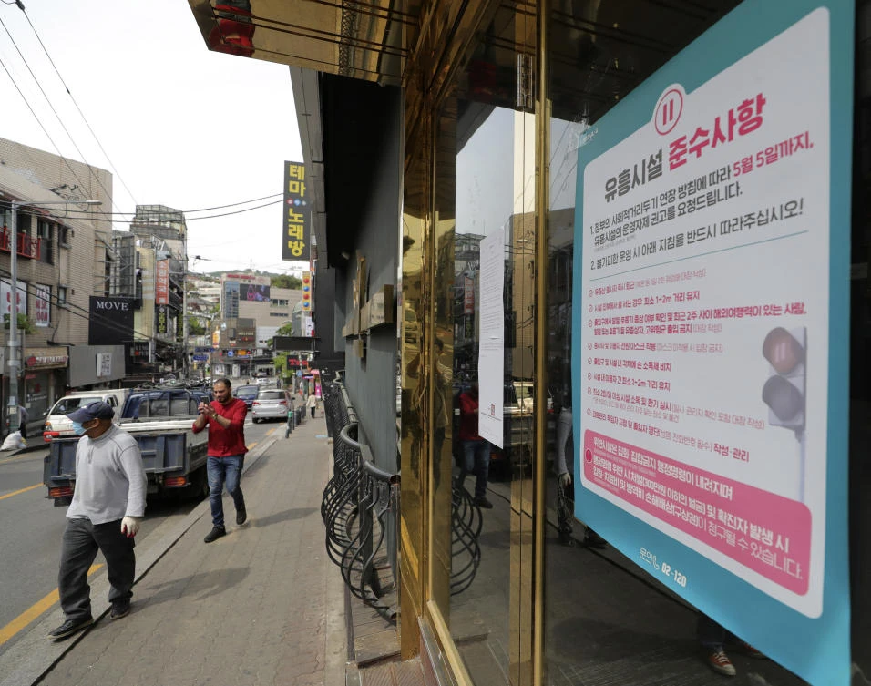 A notice of guidelines that South Korean entertainment facilities should follow is posted at the entrance of a nightclub in Seoul on Friday, May 8, 2020. (Yonhap via AP)