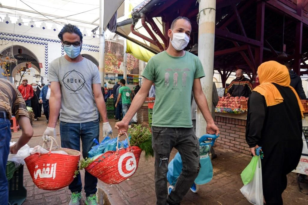 A Tunisian NGO has set up a food bank that dispenses aid by text message to some 300 needy families rendered more vulnerable because of the coronavirus pandemic. (File/AFP)