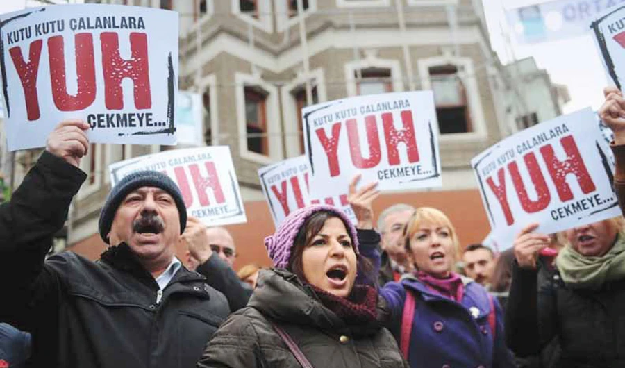 People hold placards reading ‘Shame to thieves with boxes’ during a demonstration in Istanbul against corruption and the Government. (AFP/File)