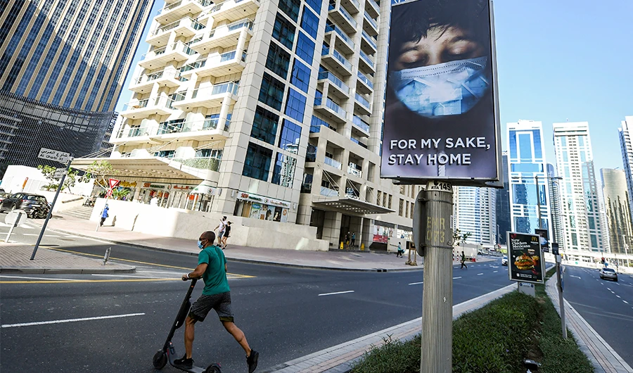 This picture taken on May 6, 2020 shows a view of an advertisement board on display in a street in Dubai, advising residents to remain at home due to the COVID-19 coronavirus pandemic. (AFP)