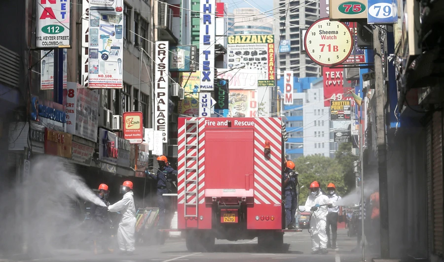 Firefighters spray disinfectants along a street in Colombo as the Sri Lankan government expects to reopen the country after almost two months locked down. (Reuters)