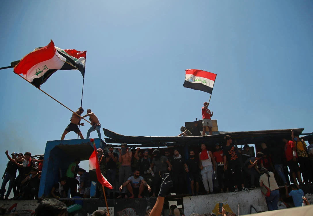 Anti-government protesters stage a sit-in on barriers set up by security forces to close the Jumhuriyah Bridge leading to the Green Zone government areas during ongoing protests, in Baghdad, Iraq, Sunday, May 10, 2020. (AP)