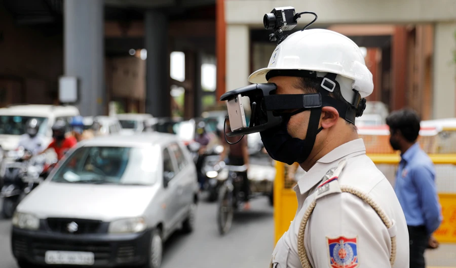 A police officer wears a thermal headgear to monitor the temperature of commuters in New Delhi. (Reuters)