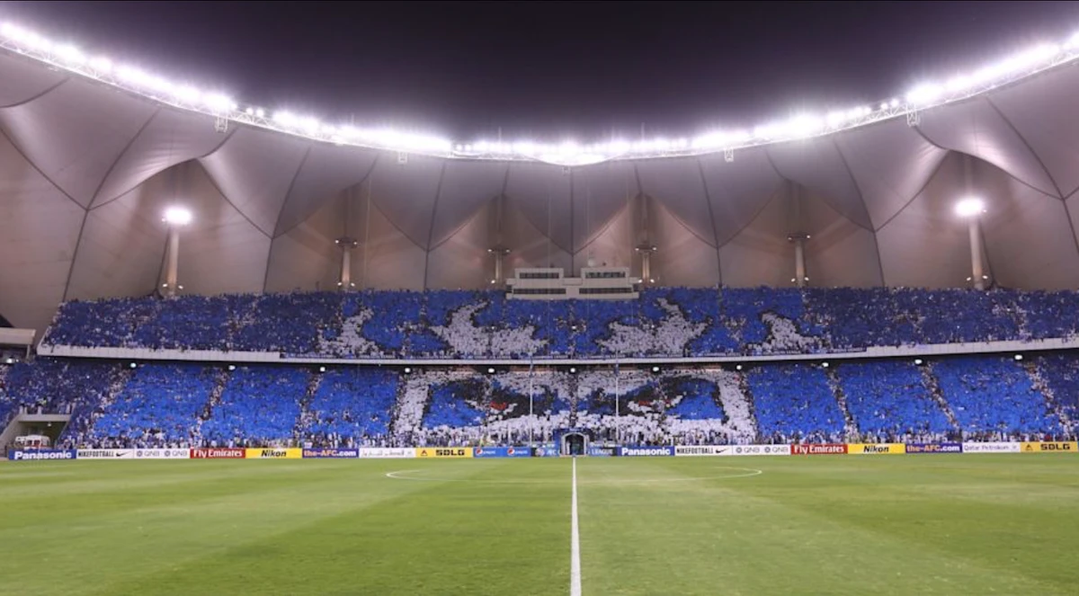 Football supporters of Saudi's Al-Hillal club hold up blue, white and red cards forming an image during their team's match against Qatar's Al-Sadd club in the AFC Champions League football match on August 19, 2014, at the King Fahd International Stadium in Riyadh. (AFP)