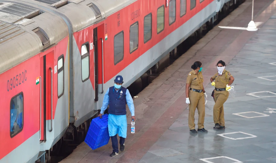 Security personnel are seen at the platform of the central railway station in Mumbai on May 12, 2020, before the train departure to New Delhi. India's enormous railway network was grinding back to life on May 12 as a gradual lifting of the world's biggest coronavirus lockdown gathered pace even as new cases surged. (AFP)