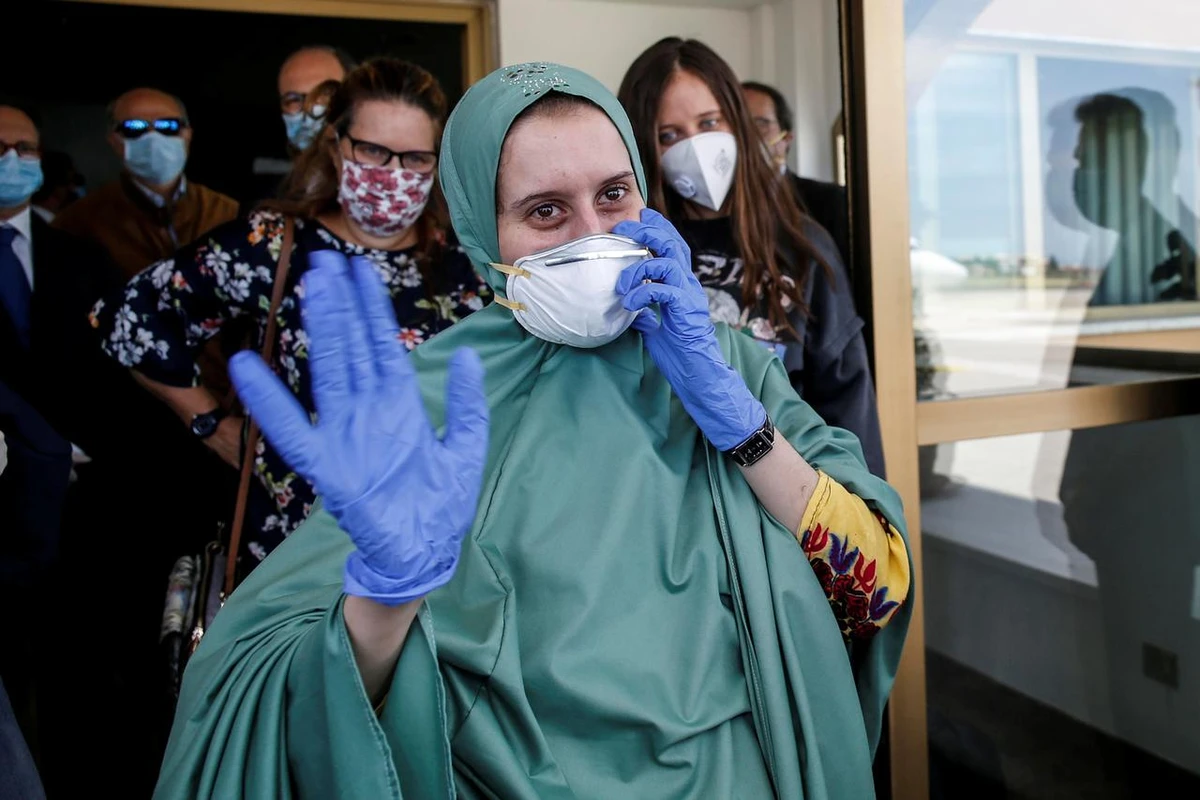 Silvia Romano, an Italian aid worker who was kidnapped by gunmen in Kenya 18 months ago, waves at Ciampino military airport in Rome, Italy, May 10, 2020. (Reuters)