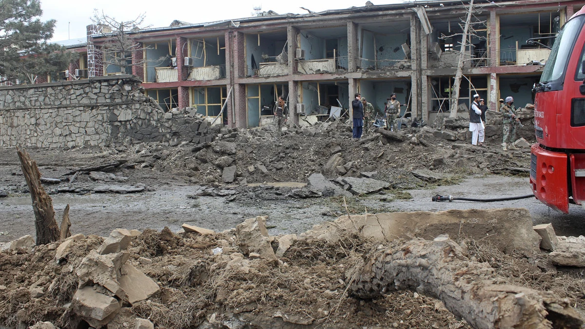 Afghan security personnel inspect the site of an attack on Afghan army base in Gardez, capital of Paktia province on May 14, 2020. (AFP)