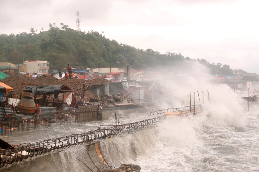 Strong waves caused by Typhoon Vongfong batter houses along the coastline of Catbalogan city in the eastern Philippines on May, 14, 2020. (AP Photo/Simvale Sayat)