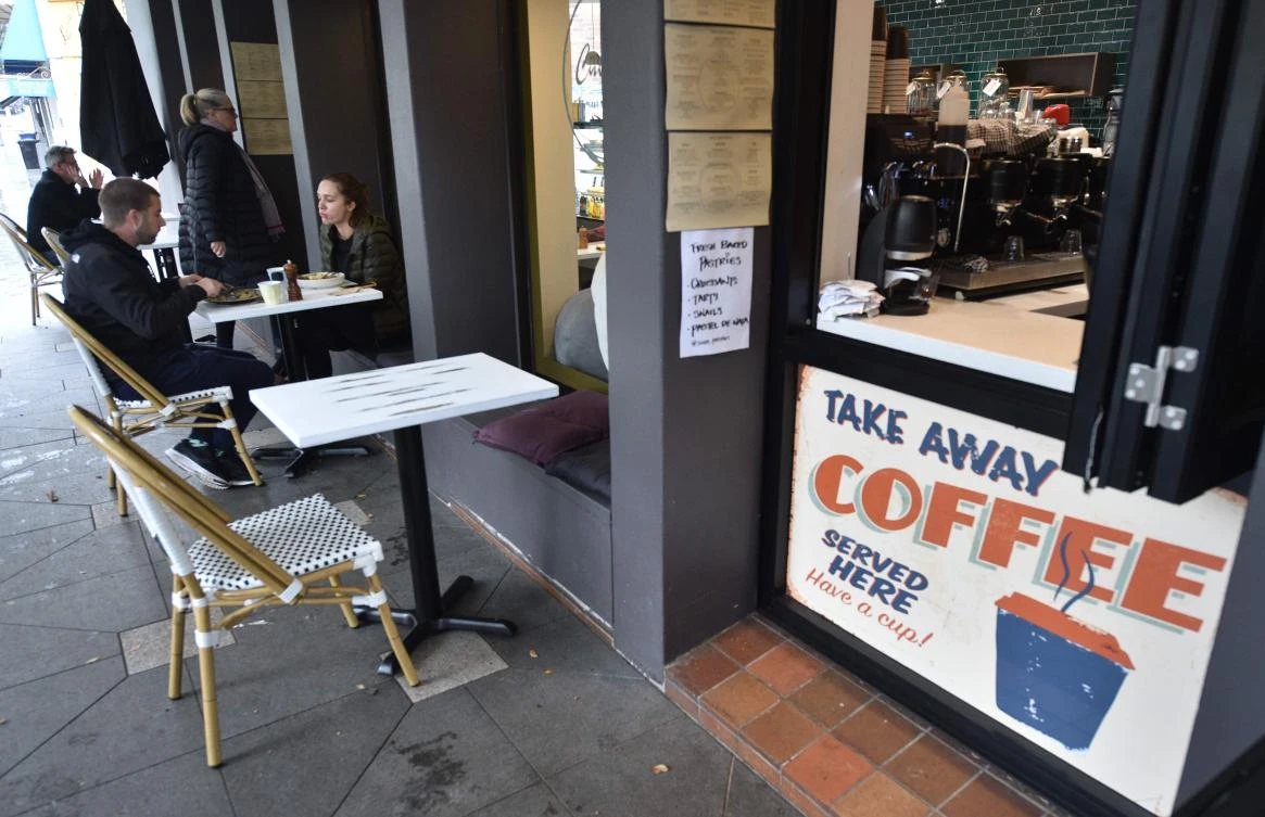 Customers eat in a cafe in Sydney after more than seven weeks of coronavirus restrictions on May 15, 2020. (AFP)