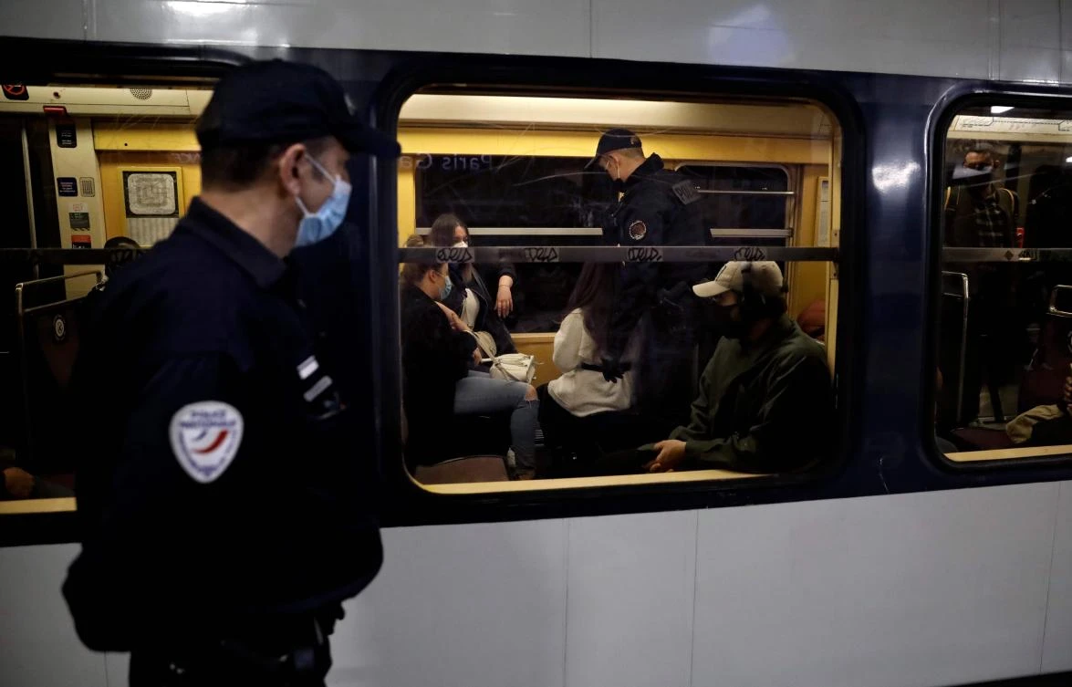 French police officers control public transport commuters during rush hour in Paris on May 15, 2020, as France eases coronavirus lockdown measures. (AFP)