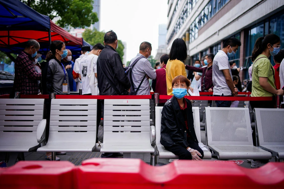 Residents stand in a queue for nucleic acid testings in Wuhan, the Chinese city hit hardest by the coronavirus disease outbreak, on May 16, 2020. (Reuters)