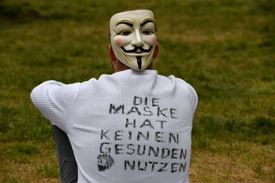 Above, a demonstrator wears a mask and a T-shirt with inscriptions reading ‘The mask has no healthy use’ during a protest against the coronavirus restrictions in Berlin on May 2, 2020. (AFP)