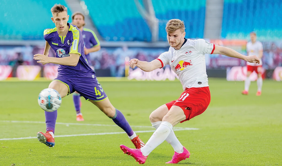RB Leipzig’s Timo Werner in action with Freiburg’s Nico Schlotterbeck on Saturday as Bundesliga matches resumed behind closed doors. (Reuters)