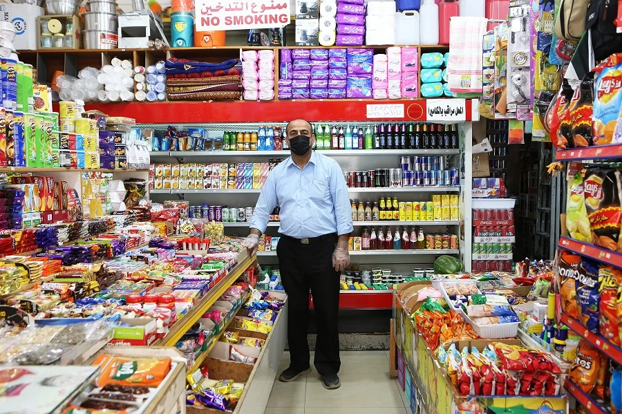 Iranian grocer Rustom Ali Mohammad, 49, is pictured at his supermarket in Kuwait City, on April 29, 2020. (File/AFP)