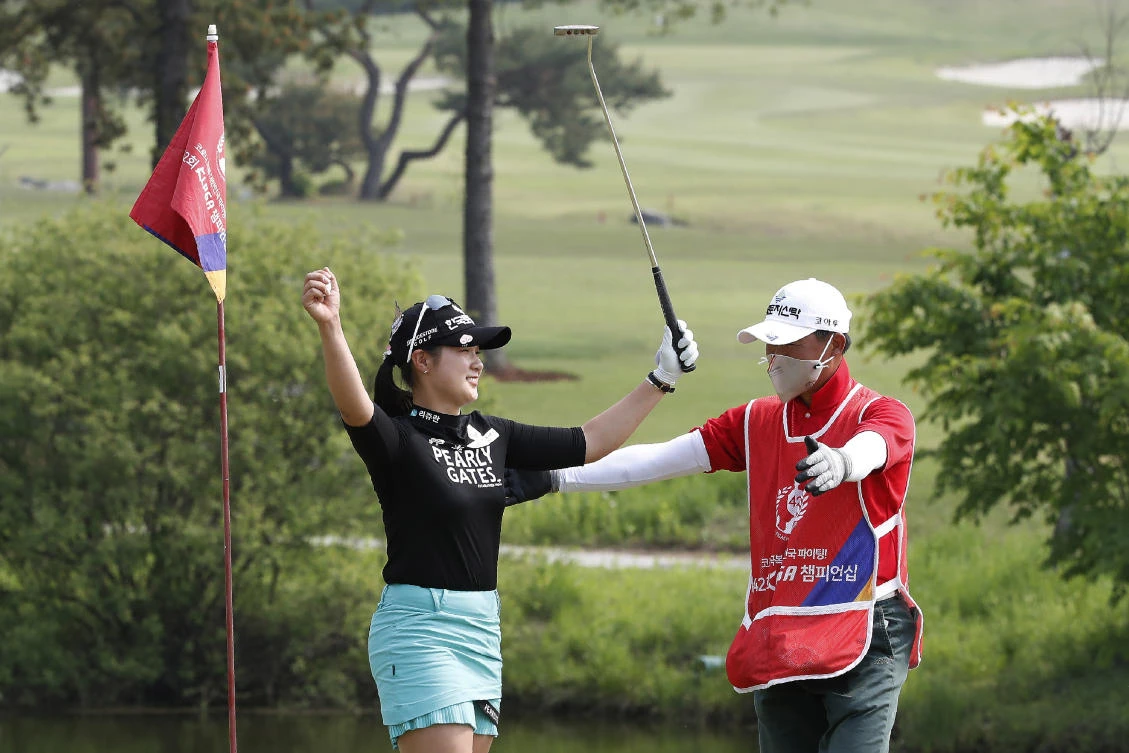 Park Hyun-kyung, left, of South Korea celebrates with her caddie after winning the KLPGA Championship on the 18th hole at the Lakewood Country Club in Yangju, South Korea on Sunday, May 17, 2020. (AP)
