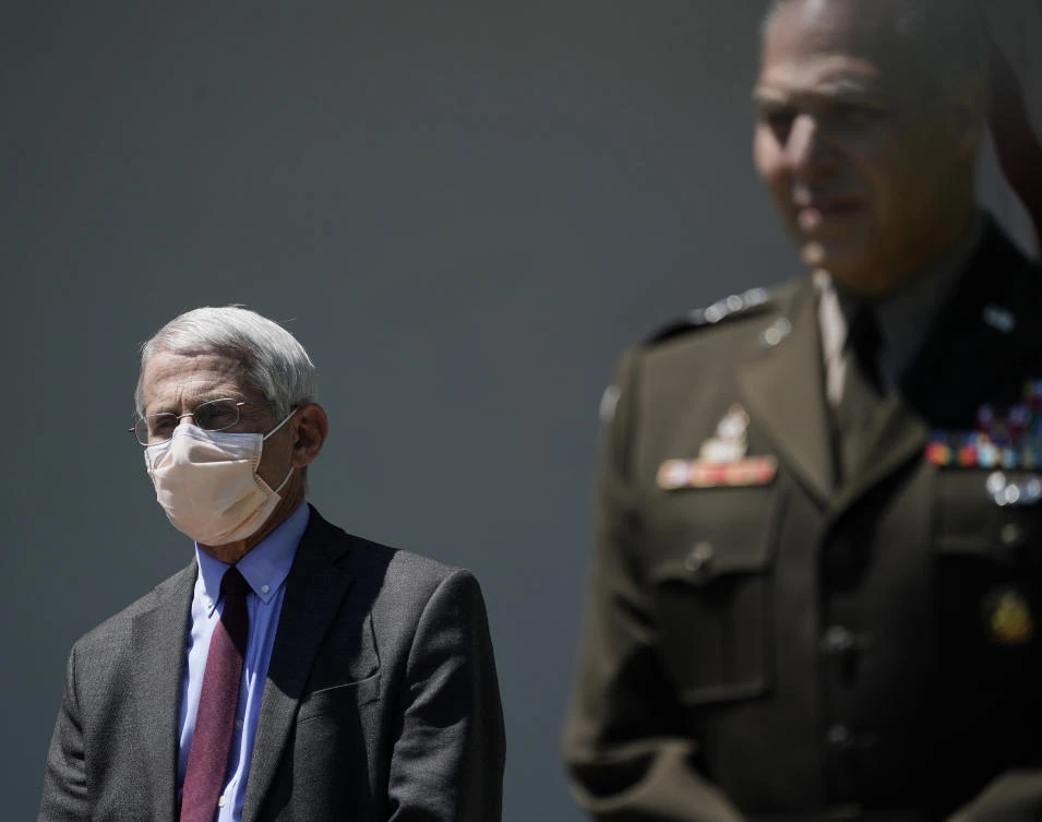 Dr. Anthony Fauci, director of the National Institute of Allergy and Infectious Diseases listens to President Donald Trump during a previous press conference in the Rose Garden of the White House on May 15. (Drew Angerer/Getty Images/AFP)