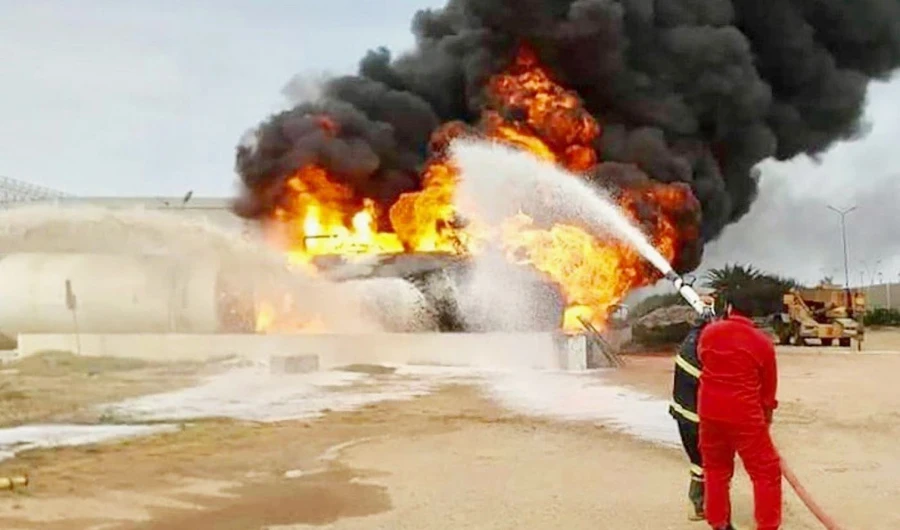 Firefighters battle blaze following attack on Mitiga airport in Libya’s capital Tripoli. (AFP/File)