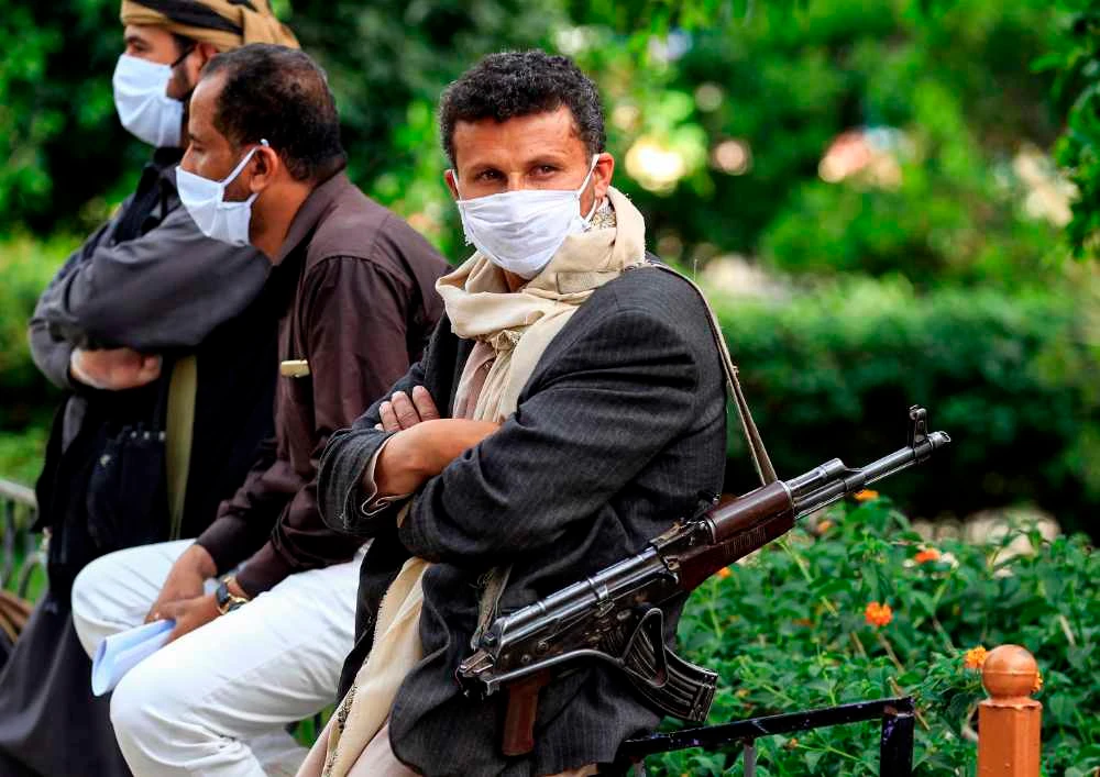 Houthi militia enforcing a community-led initiative to prevent the spread of COVID-19 coronavirus disease at a neighborhood in Yemen's capital Sanaa on May 14, 2020. (AFP / MOHAMMED HUWAIS)