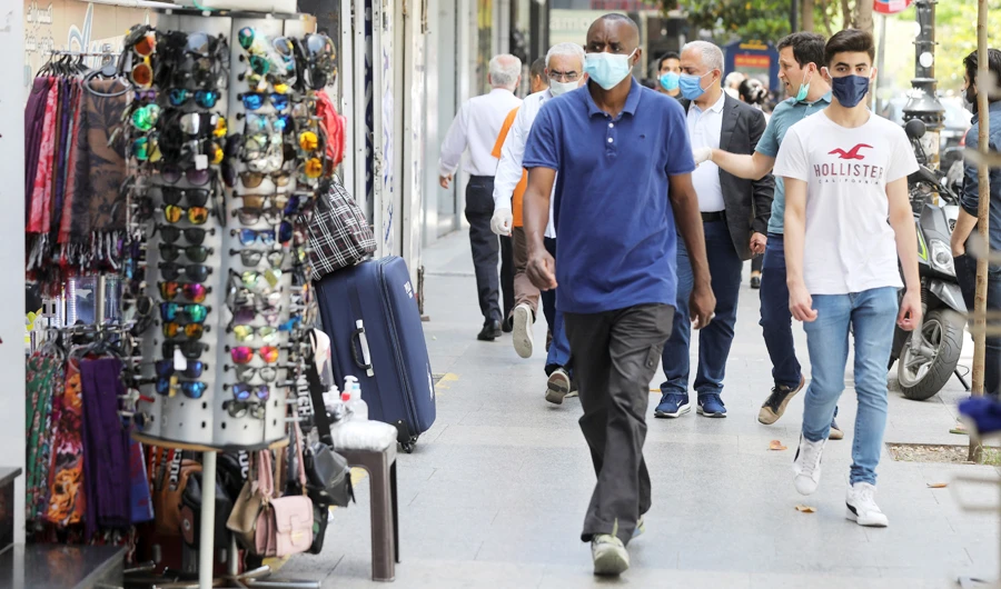 People walk past open shops in Beirut, as Lebanon is gradually reopening its economy following a shutdown imposed to curb the spread of the coronavirus. (Reuters)
