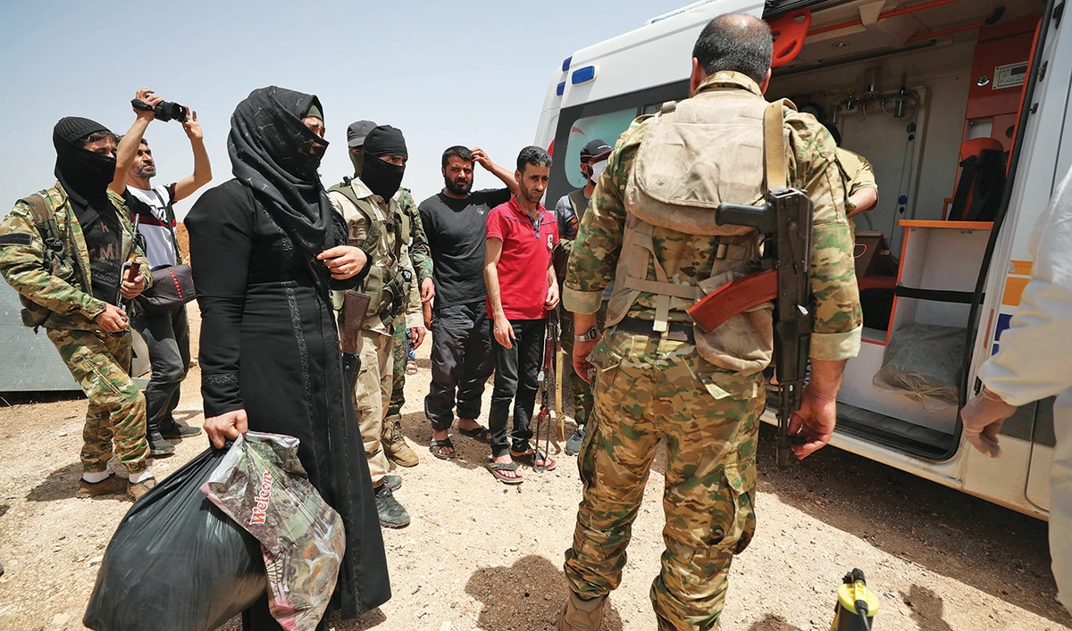A woman is released in a reported prisoner swap deal between Faylaq Al-Sham and Syrian regime forces in Tahliya, in the eastern countryside of Idlib, on Monday. (AFP)