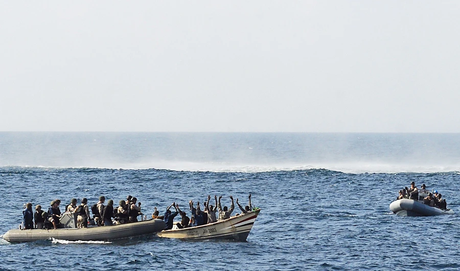 Visit, board, search and seizure (VBSS) team members from the guided-missile cruiser USS Vella Gulf (CG 72) close in on rigid-hulled inflatable boats to apprehend suspected pirates in Gulf of Aden in the Arabian Sea, in this February 12, 2009 file photo. (REUTERS)
