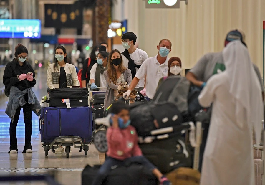 Passengers from an Emirates Airlines flight from London line up before being checked by health workers at Dubai International Airport on May 8, 2020 amid the coronavirus Covid-19 pandemic. (File/AFP)
