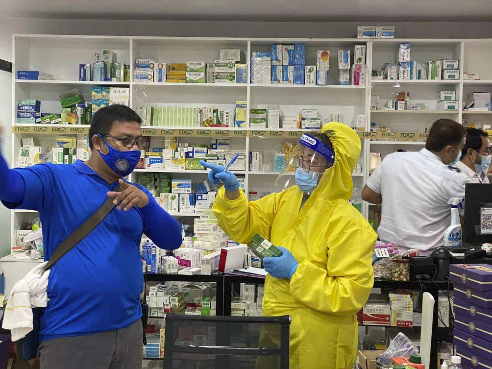 Police teams inspect a drug store on a residential villa on May 19, 2020 which was illegally turned into a medical facility catering to Chinese citizens suspected to be infected with the coronavirus disease. (CIDG Regional Field Units 3 via AP)