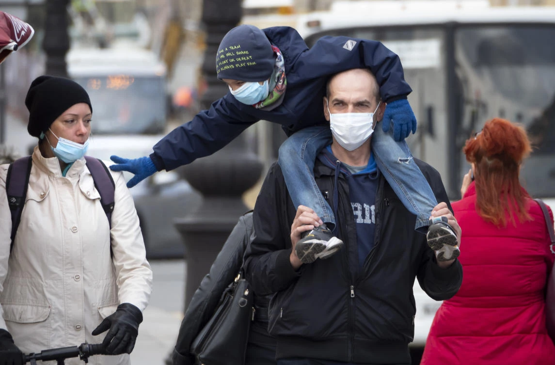 Russia has continued to see a steady rise of new infections, and new hot spots have emerged across the vast country of 147-million people. Above, a family wearing face masks to protect against coronavirus walk in St. Petersburg, Russia on May 19, 2020. (AP)